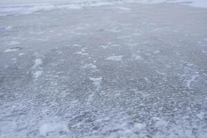 The ice is covered with snow. photo