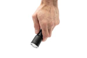 Hand holding flashlight isolated on white background photo