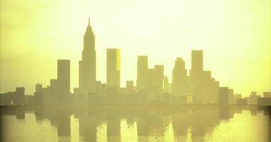 CGI City skyline basking in golden sunset glow over calm water video