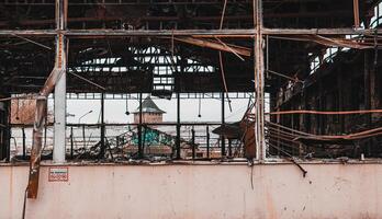 Damage to a commercial building following a structure fire. Windows broken after fire disaster, destroyed property photo