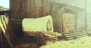 CGI Rustic wagon beside an old wooden farm structure in sunlight video