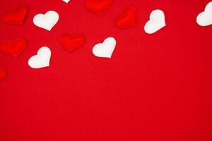 Celebration card on red background, A card decorated with hearts. Place for text, top view photo