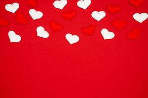 Many hearts on a red background. Festive background. Background for design. Place for text, banner, top view photo