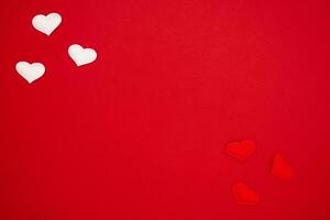 Top view red and white hearts on red background. The concept of Valentine Day. Place for text, banner photo