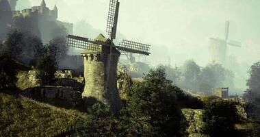 CGI Historic windmills stand majestically in a misty landscape at dawn video