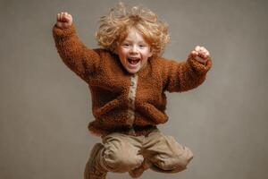 A young boy is jumping in the air photo