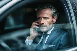 A man in a suit and tie talking on the phone photo