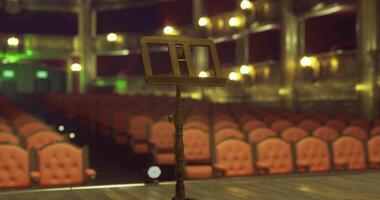 CGI Spectacular theater interior featuring an empty stage with a music stand video