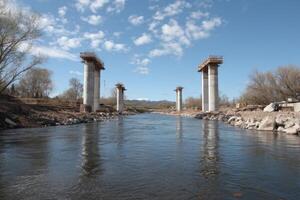 The bridge is being built over the river photo