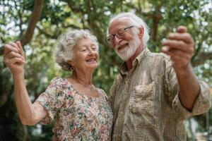 An older couple dancing in the park photo