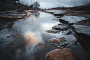 A puddle of water on the ground with rocks and rocks photo