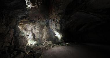 CGI Light illuminates textured rock formations within a dark cave space video