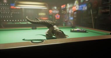CGI Billiards table with animal skull in a dimly lit bar setting video