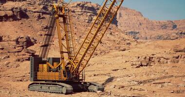 CGI Large construction crane at work in a rugged desert landscape video