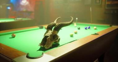 CGI Billiard table with a decorative skull in a dimly lit bar setting video