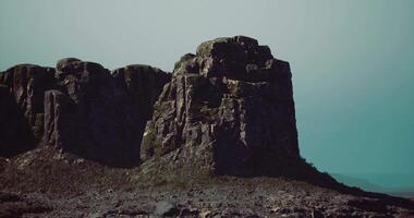 CGI Majestic rock formations stand against a foggy backdrop in a serene landscape video