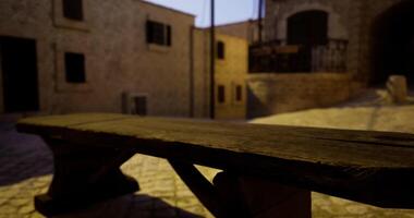 CGI Evening light casts shadows on a rustic wooden bench in a quiet alleyway video
