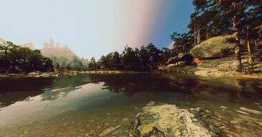 CGI Tranquil lake surrounded by towering trees and rocky landscapes during daylight video