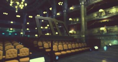 CGI Empty theater setting with music stand and illuminated chandeliers video