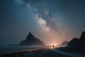 A man standing on a road at night with the milky above him photo