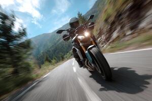 A person riding a motorcycle on a mountain road photo