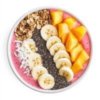 A colorful smoothie bowl made with blended tropical fruits, topped with granola, sliced bananas, chia seeds, and coconut flakes. A nutritious and visually appealing breakfast. Isolated on clean white background photo