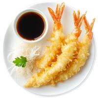 A plate of golden-brown tempura shrimp, delicately battered and deep-fried to a crispy perfection, served with a side of light soy-based dipping sauce and a garnish of shredded daikon radish. A classic Japanese dish that showcases a perfect balance of tex photo