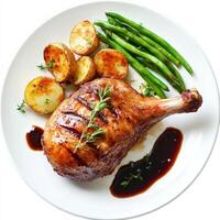 A plate of duck confit, duck leg preserved and slow-cooked in its own fat, resulting in tender and flavorful meat with crispy skin, served with roasted potatoes and a side of green beans, garnished with fresh herbs and a drizzle of balsamic glaze, isolate photo
