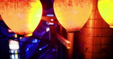 CGI Vibrant lanterns illuminate a lively street at night in an urban setting video