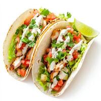 A vibrant taco trio with soft corn tortillas filled with grilled chicken, fresh salsa, shredded lettuce, and a drizzle of creamy sauce. Each taco is garnished with chopped cilantro and lime wedges for an authentic Mexican flavor. Isolated on clean white b photo