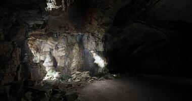 CGI Exploring the dark depths of an underground cavern illuminated by lights video