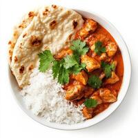 A bowl of fragrant Indian chicken tikka masala, featuring tender, marinated chicken pieces simmered in a rich, creamy tomato-based curry sauce. Served with a side of warm, buttery naan bread and fluffy basmati rice, garnished with fresh cilantro for a vib photo