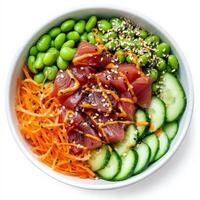 A vibrant poke bowl filled with sushi-grade tuna, avocado, edamame, shredded carrots, and sliced cucumbers, drizzled with a savory soy-sesame dressing and sprinkled with sesame seeds. Isolated on clean white background photo