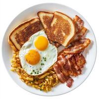 A hearty breakfast plate featuring crispy bacon, sunny-side-up eggs, golden hash browns, and buttered toast. The perfect combination of textures and flavors for a satisfying morning meal. Isolated on clean white background photo
