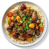 A bowl of Moroccan tagine, infused with the smoky and savory flavors of Texas barbecue, featuring slow-cooked lamb, vegetables, apricots, dates, and smoky barbecue sauce, served over couscous, a fusion of two distinct and flavorful culinary traditions, is photo