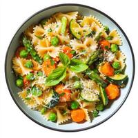 A vibrant bowl of pasta primavera, featuring pasta tossed with fresh spring vegetables, such as asparagus, peas, zucchini, and carrots, in a light cream or garlic sauce, garnished with fresh herbs and grated parmesan cheese, isolated on clean white backgr photo