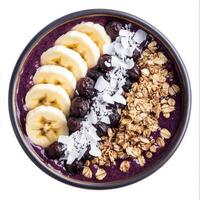 A refreshing acai bowl, filled with blended acai berries, topped with banana slices, granola, shredded coconut, and a drizzle of honey. A vibrant and healthy breakfast option. Isolated on clean white background photo