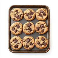 A tray of freshly baked chocolate chip cookies, slightly crisp on the edges with gooey melted chocolate chunks inside. The cookies are arranged in a cozy, homemade style. Isolated on clean white background photo