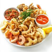 A vibrant platter of mixed fried seafood, featuring calamari, shrimp, and whitebait, battered and fried until crispy, served with a side of lemon wedges and marinara sauce, a popular Italian appetizer, isolated on clean white background. photo