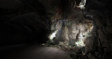 CGI Exploring a dimly lit cave with textured rock formations and shadows video