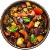 A close-up of a classic ratatouille, a colorful vegetable stew with eggplant, zucchini, bell peppers, tomatoes, onions, and herbs, simmered until tender and flavorful, served in a rustic bowl, showcasing the vibrant colors and the fresh taste of summer ve photo