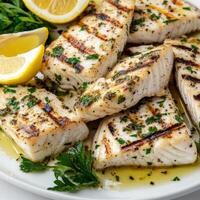 A plate of grilled swordfish with Salmoriglio sauce, featuring thick slices of fresh swordfish, grilled to perfection and seasoned with salt, pepper, and a drizzle of olive oil, served with a vibrant Salmoriglio sauce, made from fresh oregano, parsley, ga photo