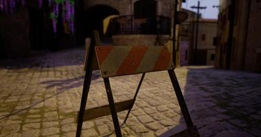CGI Construction barrier in quaint cobblestone street during evening hours video