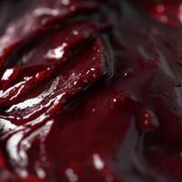 A close up of a red sauce with some liquid photo