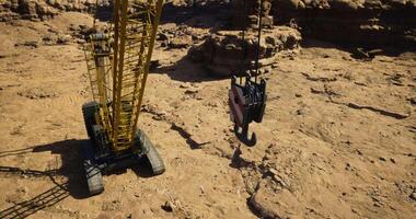 CGI Heavy lifting equipment operates in rugged terrain for construction project video