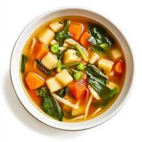 A bowl of soup with vegetables and noodles photo