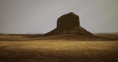 CGI Unique rock formation stands tall in a vast desert landscape at dusk video
