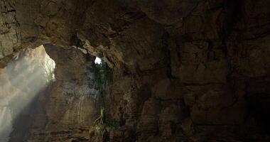 CGI Exploration of a cavern with sunlight filtering through rocky formations video
