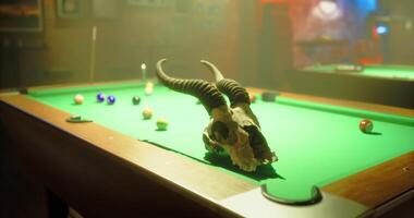CGI Unique decor features a ram skull on a vibrant pool table in low light video