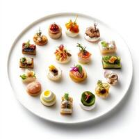 A white plate with various small appetizers on it photo